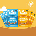 Four Paleo Foods Co. granola snack packs fanned out against a warm yellow and brown background.