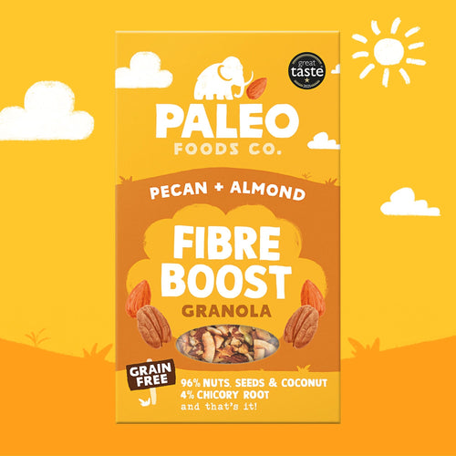 A package of Paleo Foods Co. Pecan + Almond Fibre Boost Granola centered on a bright yellow illustrated background with clouds, a sun, and orange ground shapes.